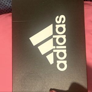 Adidas Shoes. black and white with a light cream color on the bottom of the shoe